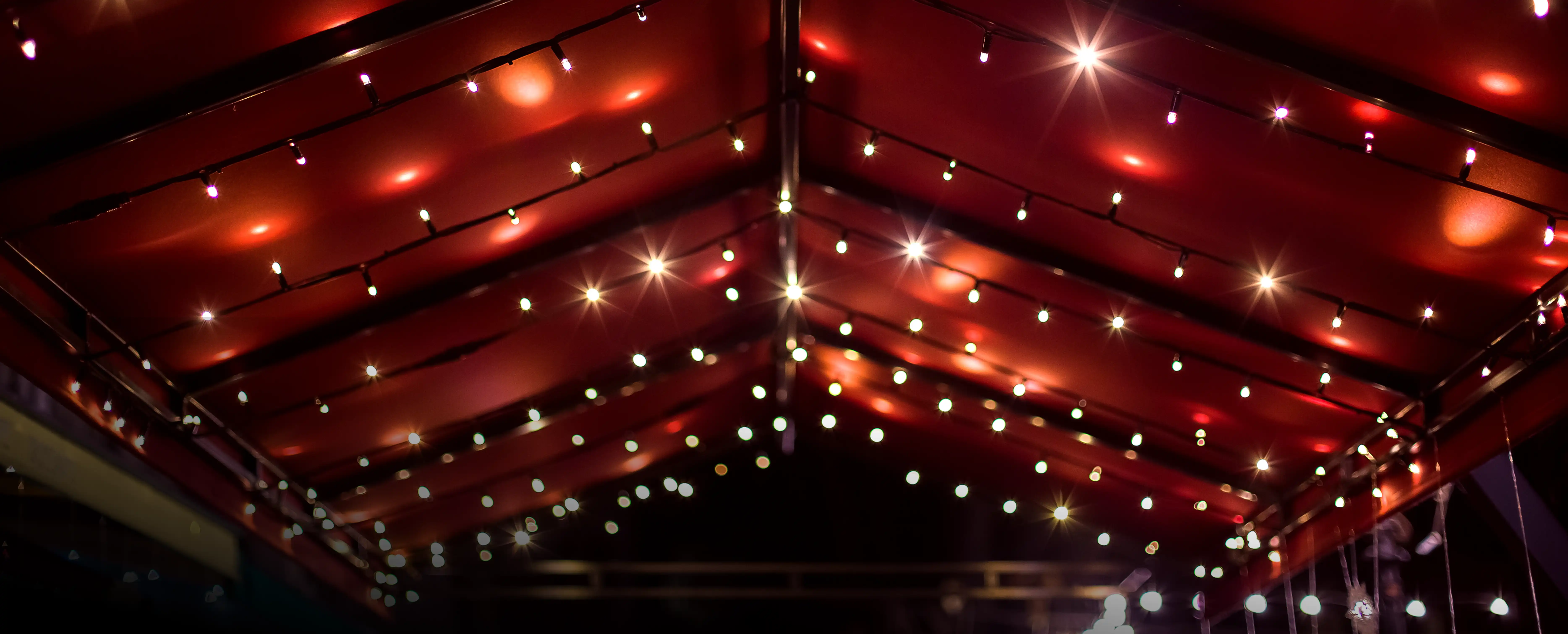 Festival tent at night with lighting.
